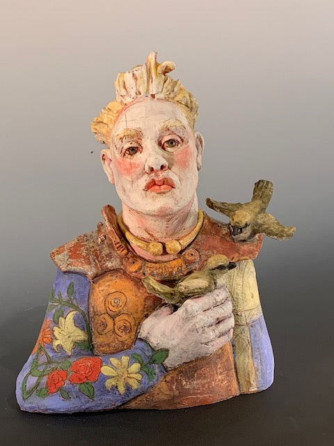 Colorful figurine with decorative clothing and accessories on a gray background