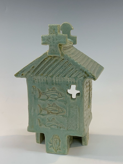 Green ceramic building with cut-outs
