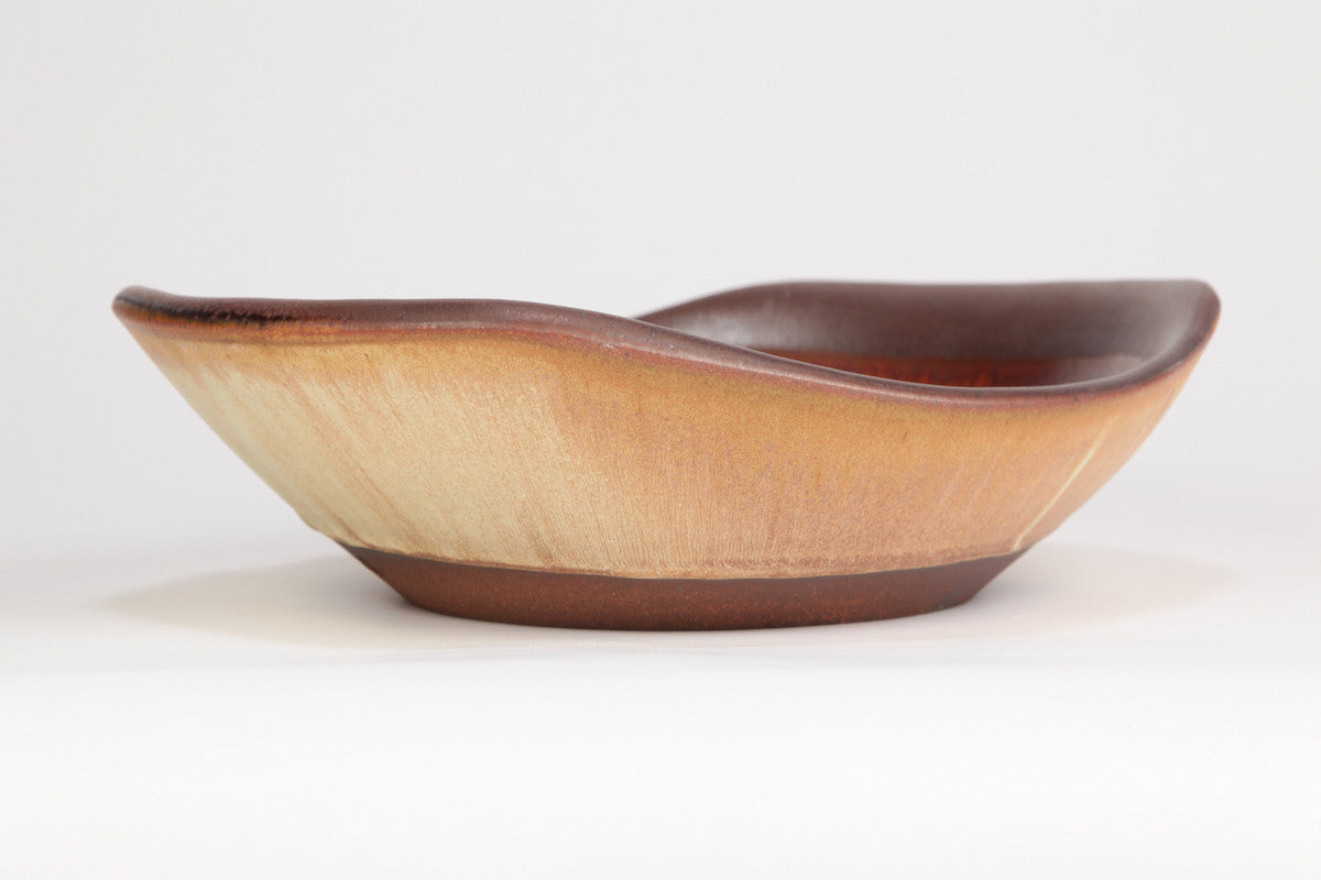 Brown ceramic bowl on a white background