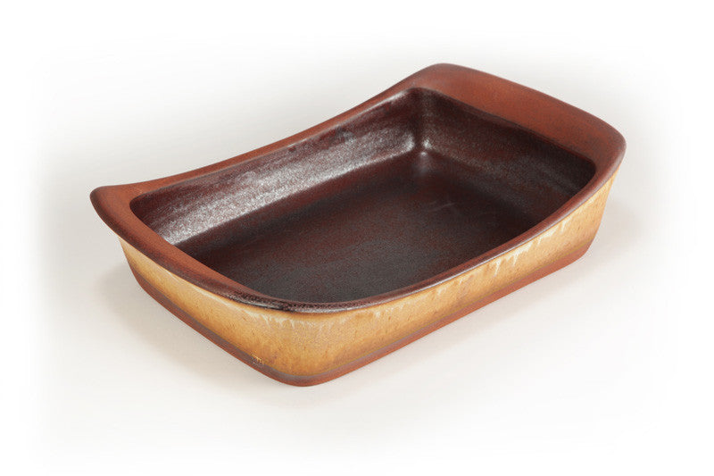 Rectangular ceramic baking dish with brown and gold finish on a white background