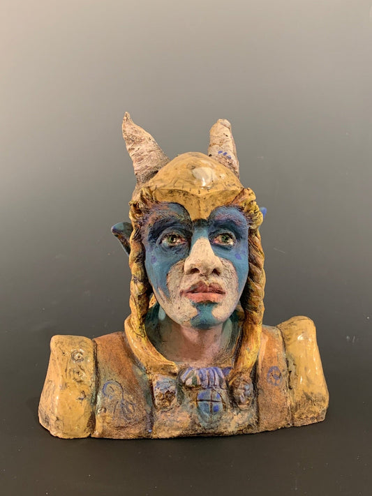 Small figurine with a face on a dark background